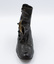 Image shows the front view of the right shoe from a pair of button-up boots with some of the inner lining revealed.