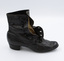 Image shows the right-hand side of the right shoe from a pair of black button-up boots. Some of the inside of the buttonholes are revealed.