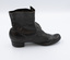 Image shoes the right-hand side of the left boot from a pair of black button-up boots.
