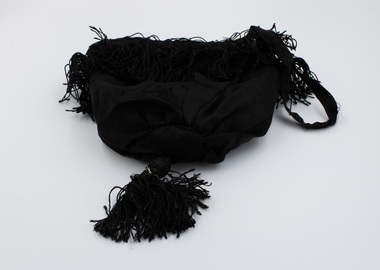 Black drawstring bag with tassels