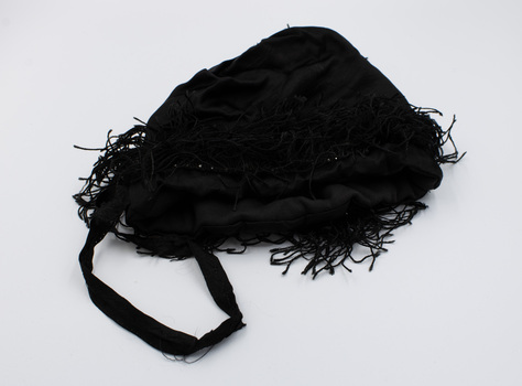 Black drawstring bag with handle in the foreground
