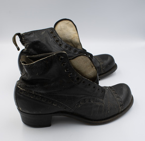 A pair of black low-heeled boots with their right sides facing the camera.