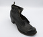 A single black low-heeled left boot, angled with the toe and right side facing the camera.