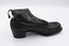 A single black low-heeled boot, with the right side facing the camera.