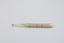 A dairy thermometer, with markings denoting appropriate temperatures for Freezing, Churning Cheese facing the camera.