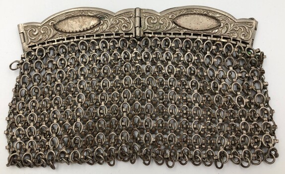 Silver mesh chainmail evening bag. Clutch style handles missing four stones - possibly moonstones.