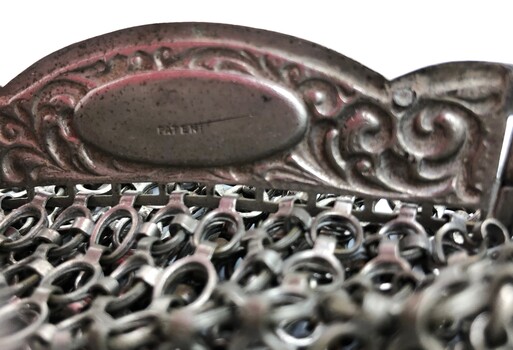 Maker's mark 'Patent' engraved inside clutch handle of evening bag.