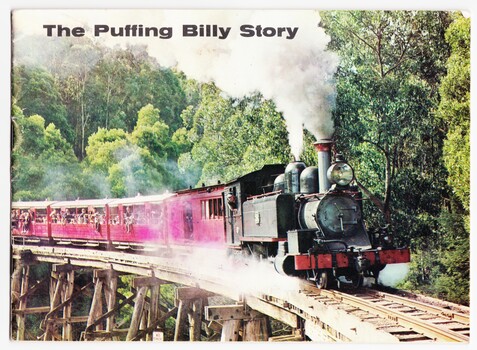 Photograph of Puffing Billy on the trestle bridge at Selby with bush in the background.