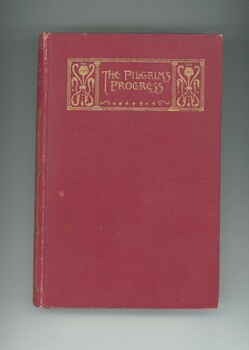 Front cover is red and has a gold embossed book title positioned on the top quarter of the book. 