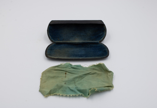 Open glasses case and opened out cleaning cloth