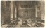 Dining hall with long refectory tables and bench seats, wood paneled walls and paintings hung on walls.