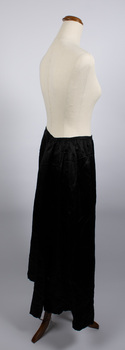 Side view of long black petticoat worn on mannequin