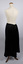 Side view of long black petticoat worn on mannequin