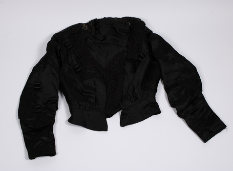 Front view of black bodice laid flat