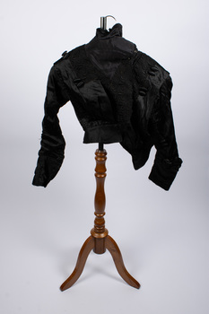 Front view of black bodice on stand