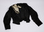 Front view of black bodice laid flat with cream inset visible