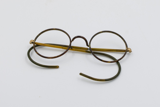Broken pair of metal spectacles with no lenses