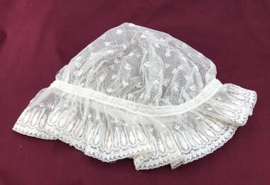 Mob cap made of cream lace with gathered lace trim.