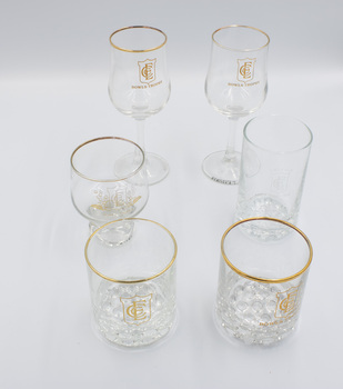 Six Emerald Country Club glasses including two wine glasses, one short-stemmed glass, one plain glass and two gold-rimmed glasses with bubble bases.