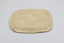 Upside down view of rectangular cream-colored ceramic plate with decorative edging.