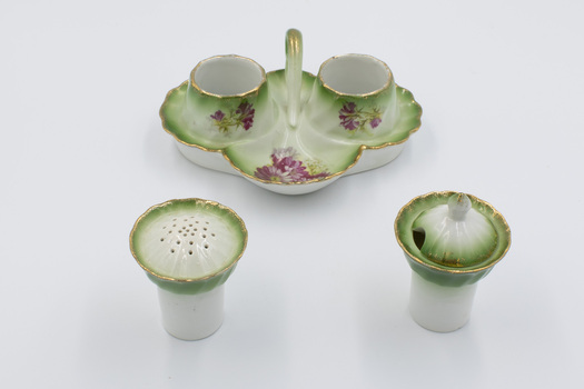 Ceramic cruet set with pepper dispenser and salt cellar separate. 