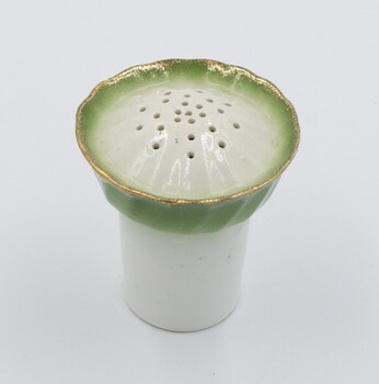 Ceramic pepper dispenser - green band with gold rim on white background.