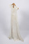 Side view of long, cream-colored christening gown on a stand