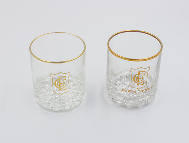 Two Emerald Country Club trophy glasses with gold rims and ECC logo and Trophy Glass wording on the front.