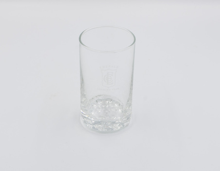 One plain drinking glass with ECC logo on side.
