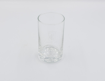 One plain drinking glass with ECC logo on side.