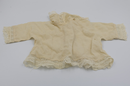 Back of jacket showing the lace edges of the arms, collar and bottom of jacket