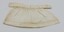 Back view of cream-colored doll's apron laid flat.