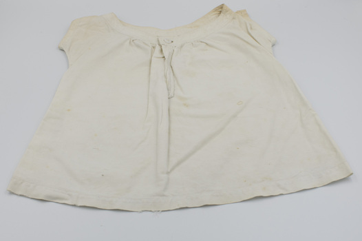 Front of baby bodice with round collar and front button fastening.