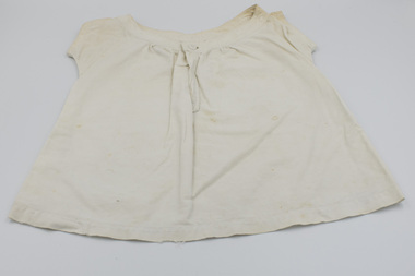 Front of baby bodice with round collar and front button fastening.