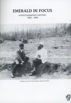 Title page of book, Emerald in Focus, with title and black and white photo of two men in conversation, sitting outside.