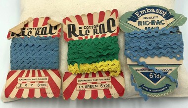 Three packets of Ric Rac trim - two packets have blue trim and the third has green trim and yellow trim.