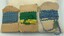 Back of three packets with Ric Rac trim - two with blue trim and one with green trim and yellow trim.