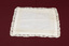Lace-trimmed white handkerchief laid flat.