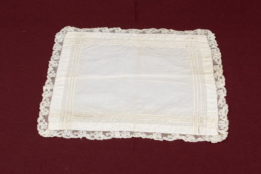 Lace-trimmed white handkerchief laid flat.