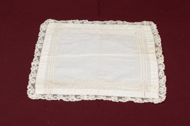 Lace-trimmed white handkerchief laid flat.