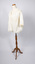 Angled view of ladies jacket, cream-colored, on mannequin.