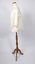 Side view of cream-colored ladies jacket on mannequin with one lace-trimmed sleeve visible