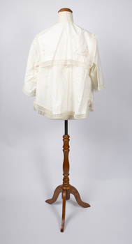 Back view of cream-colored ladies jacket showing sailor style of collar worn on mannequin.
