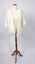 Cream-colored ladies jacket opened at the front.