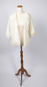 Cream-colored ladies jacket opened at the front.