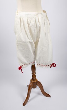 Front of cotton drawers with red ribbon trimming at knees