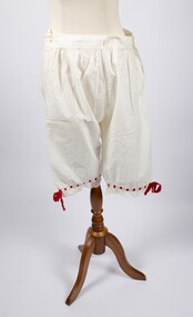 Front of cotton drawers with red ribbon trimming at knees