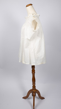 Side view of cream-colored chemise on mannequin