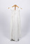 Front view of christening gown hung from wooden hanger