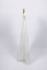 Side view of christening gown hung from wooden hanger